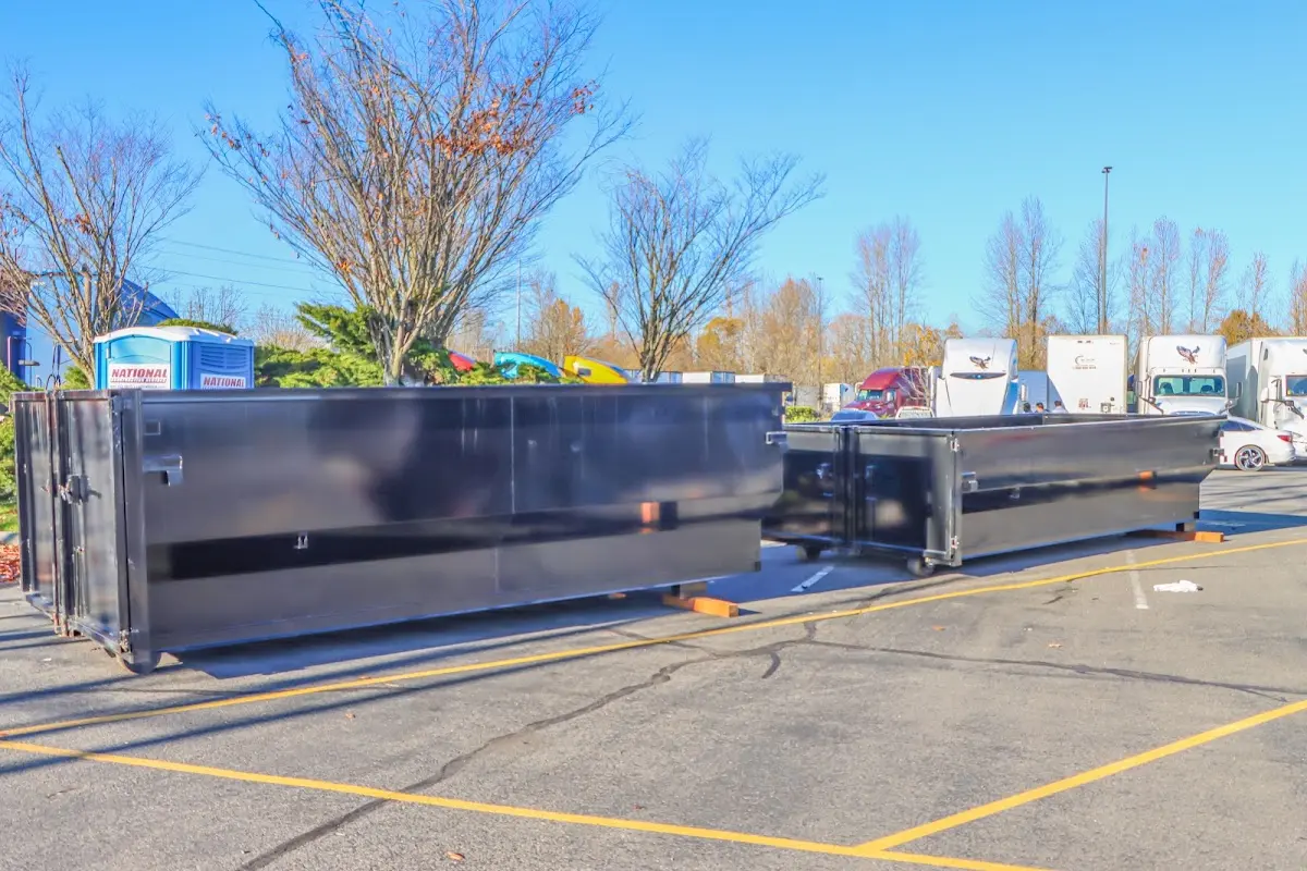 Professional dumpster rental service with roll-off container on residential driveway in Bayou Blue